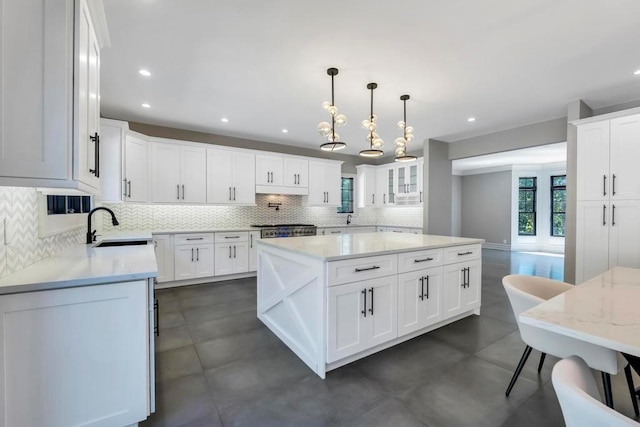 589 Old Bridge Rd, Northport, NY 11768 - kitchen with a center island, tasteful backsplash, light stone counters, white cabinetry, and recessed lighting