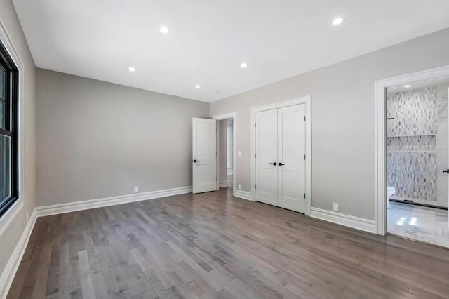 589 Old Bridge Rd, Northport, NY 11768 - unfurnished bedroom with wood finished floors, recessed lighting, and connected bathroom