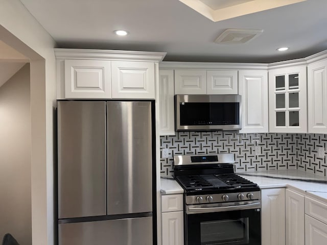 4642 Murdock Ave, Bronx, NY 10466 - kitchen with stainless steel appliances, white cabinetry, glass insert cabinets, backsplash, and recessed lighting