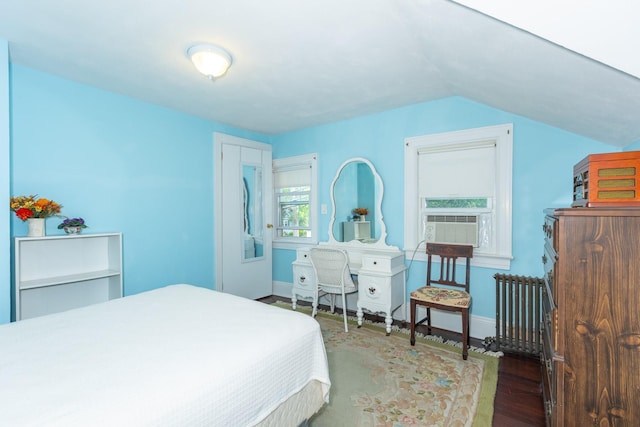 53 Community Rd, Bay Shore, NY 11706 - bedroom featuring wood finished floors, radiator, vaulted ceiling, and cooling unit
