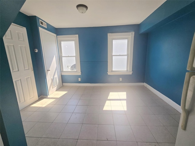 33 Thorne Ave, Hempstead, NY 11550 - unfurnished bedroom with multiple windows and tile patterned floors
