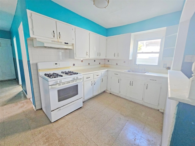 33 Thorne Ave, Hempstead, NY 11550 - kitchen with white gas stove, under cabinet range hood, white cabinetry, and light countertops