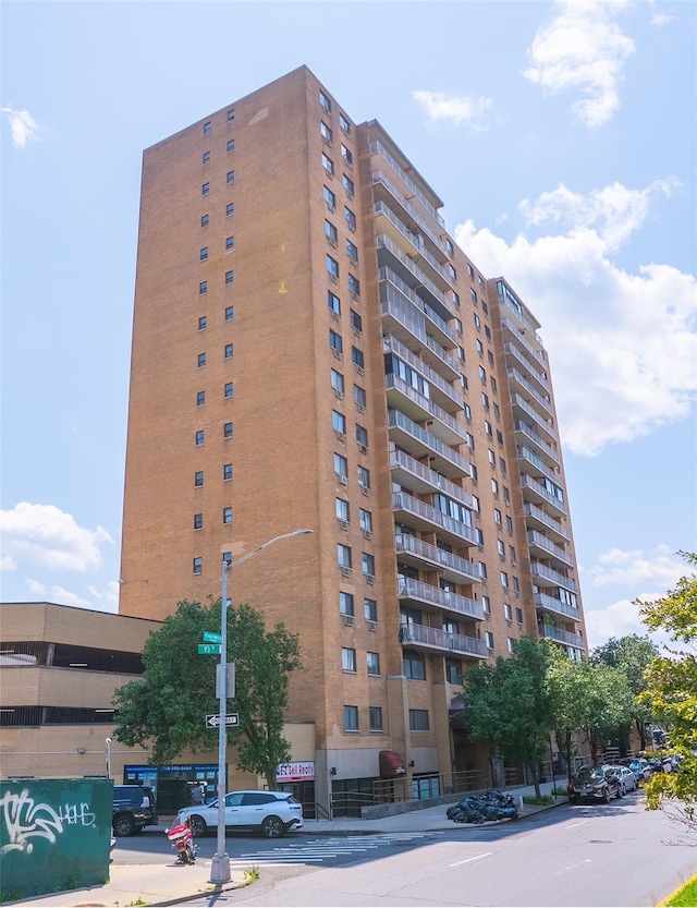 92-29 Queens Blvd Unit 14B, Rego Park, NY 11374 - view of apartment building / complex featuring uncovered parking
