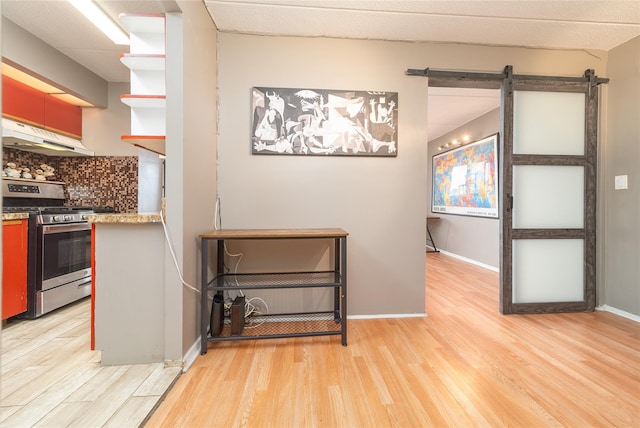 92-29 Queens Blvd Unit 14B, Rego Park, NY 11374 - kitchen with stainless steel gas stove, under cabinet range hood, light wood finished floors, backsplash, and open shelves
