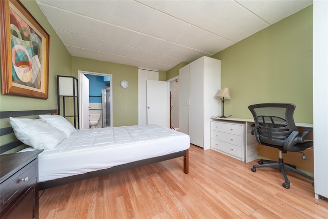 92-29 Queens Blvd Unit 14B, Rego Park, NY 11374 - bedroom with light wood-type flooring, an office area, and ensuite bathroom