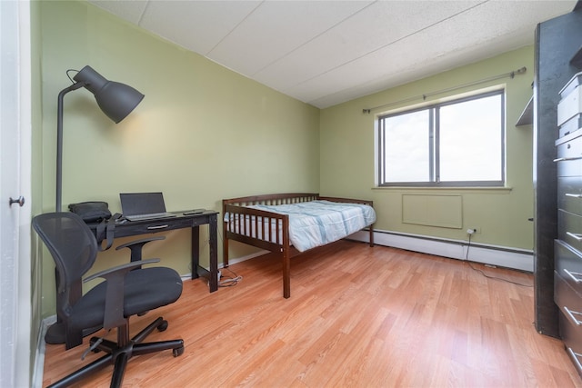 92-29 Queens Blvd Unit 14B, Rego Park, NY 11374 - bedroom with a baseboard radiator, wood finished floors, vaulted ceiling, and an office area