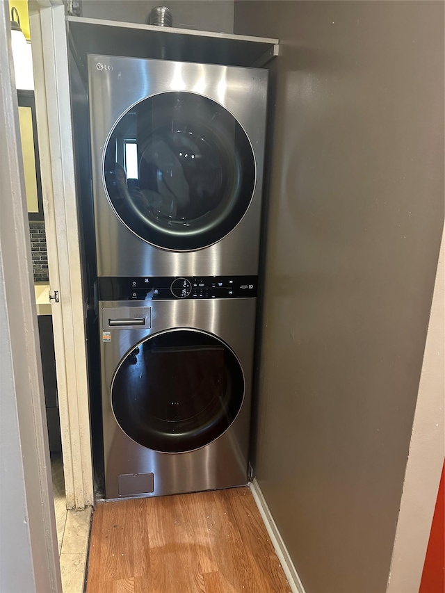 92-29 Queens Blvd Unit 14B, Rego Park, NY 11374 - laundry room featuring stacked washer and clothes dryer and wood finished floors