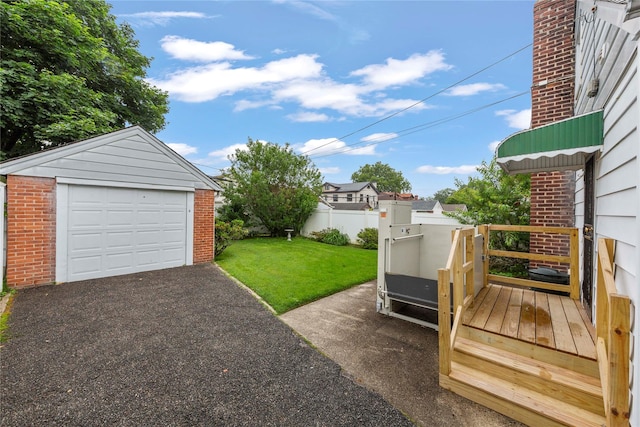 48-67 187th St, Fresh Meadows, NY 11365 - view of grassy yard with an outbuilding, asphalt driveway, and a garage