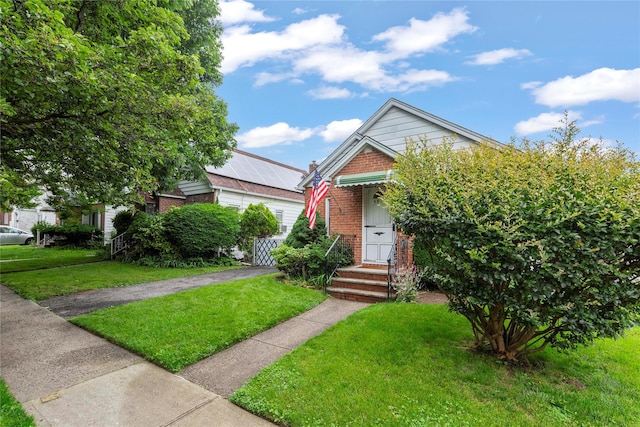 48-67 187th St, Fresh Meadows, NY 11365 - view of front of house with a front yard and brick siding