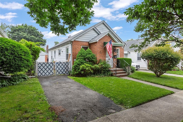 48-67 187th St, Fresh Meadows, NY 11365 - view of front of property featuring brick siding and a front yard