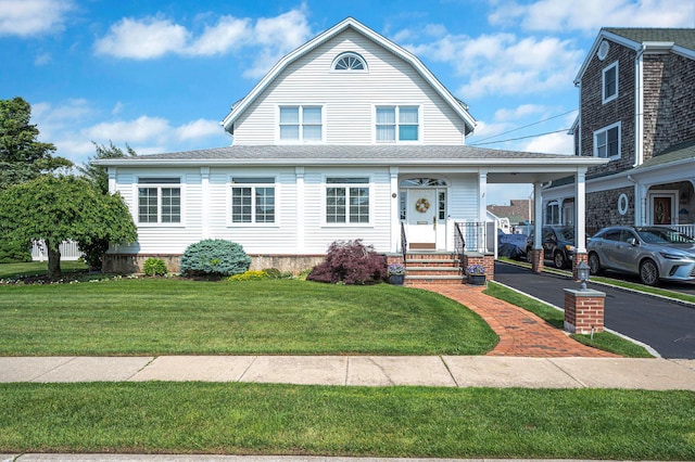 33 S Bay Ave, Amityville, NY 11701 - view of front facade with a front lawn, a gambrel roof, and driveway