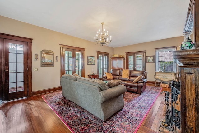 33 S Bay Ave, Amityville, NY 11701 - living room with french doors, a chandelier, and wood finished floors