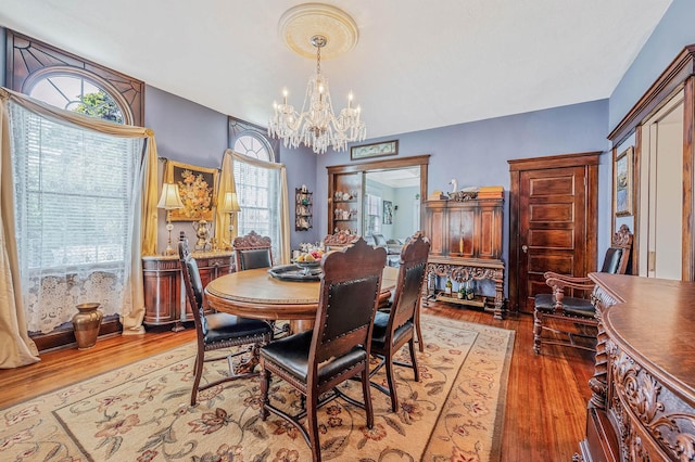 33 S Bay Ave, Amityville, NY 11701 - dining space featuring a chandelier and wood finished floors