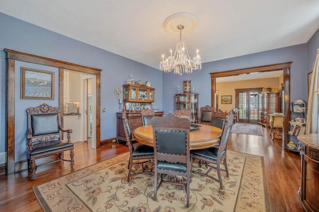 33 S Bay Ave, Amityville, NY 11701 - dining space with a chandelier and wood finished floors