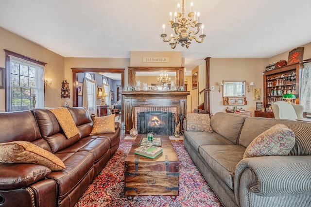 33 S Bay Ave, Amityville, NY 11701 - living area featuring a chandelier and a brick fireplace