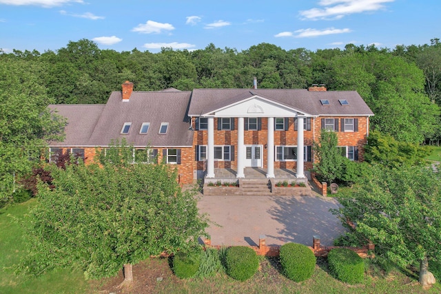 285 Hill Rd, Goshen, NY 10940 - view of front facade featuring brick siding, a chimney, and a forest view