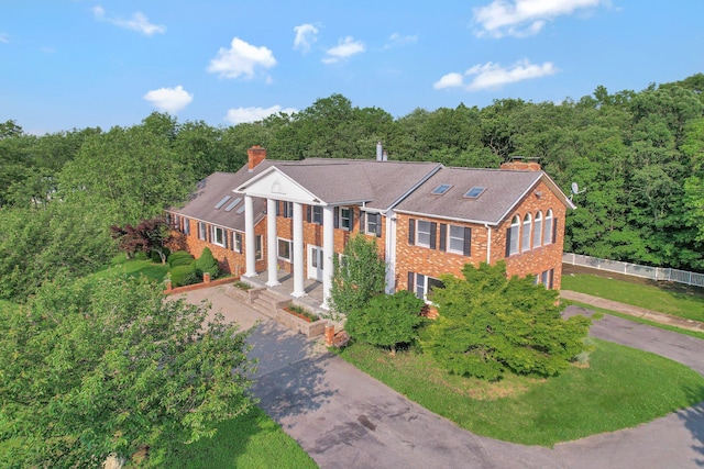 285 Hill Rd, Goshen, NY 10940 - greek revival inspired property featuring asphalt driveway, a chimney, brick siding, and an attached garage