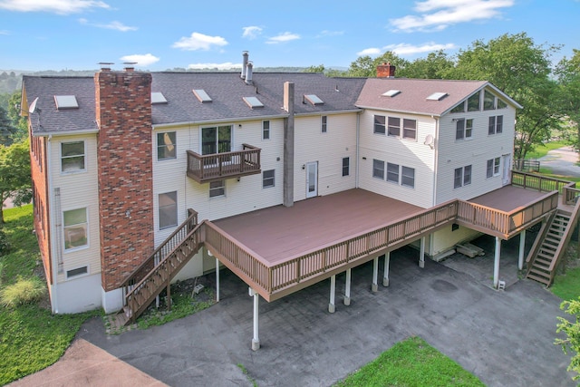 285 Hill Rd, Goshen, NY 10940 - back of house with stairs, a chimney, a wooden deck, and a shingled roof