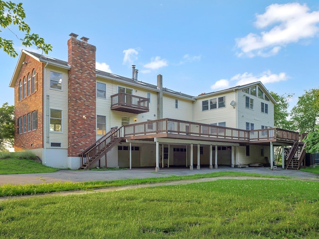 285 Hill Rd, Goshen, NY 10940 - back of house featuring stairway, a lawn, a wooden deck, and asphalt driveway