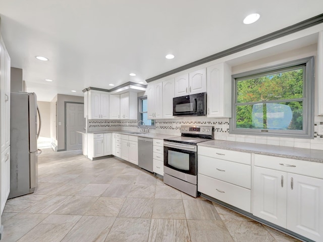 285 Hill Rd, Goshen, NY 10940 - kitchen featuring stainless steel appliances, decorative backsplash, light countertops, white cabinets, and recessed lighting