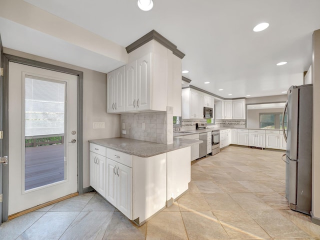 285 Hill Rd, Goshen, NY 10940 - kitchen featuring appliances with stainless steel finishes, decorative backsplash, white cabinets, light stone counters, and recessed lighting