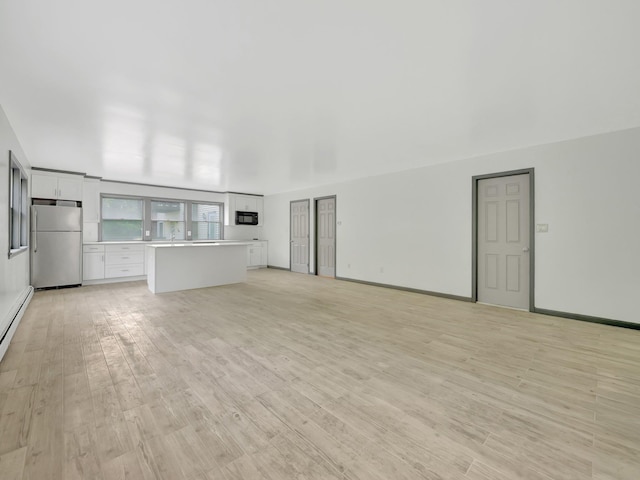 285 Hill Rd, Goshen, NY 10940 - unfurnished living room with light wood-type flooring