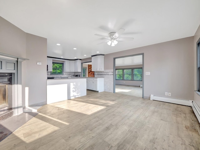 285 Hill Rd, Goshen, NY 10940 - unfurnished living room with a baseboard radiator, a ceiling fan, light wood finished floors, and recessed lighting