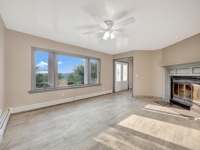 285 Hill Rd, Goshen, NY 10940 - unfurnished living room featuring baseboard heating, ceiling fan, a glass covered fireplace, light wood-type flooring, and a baseboard heating unit