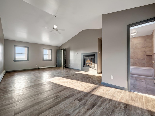 285 Hill Rd, Goshen, NY 10940 - unfurnished living room featuring a glass covered fireplace, ceiling fan, a baseboard radiator, wood finished floors, and lofted ceiling