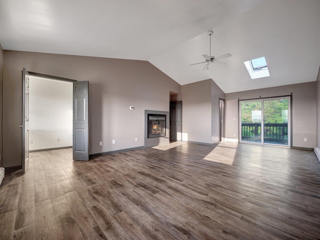285 Hill Rd, Goshen, NY 10940 - unfurnished living room with ceiling fan, high vaulted ceiling, wood finished floors, a skylight, and a glass covered fireplace