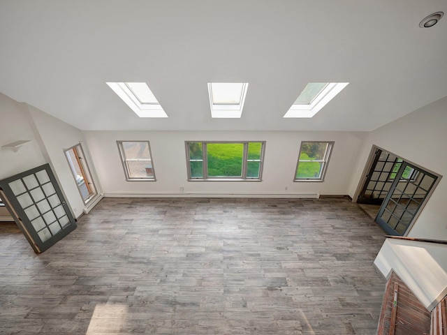 285 Hill Rd, Goshen, NY 10940 - unfurnished living room featuring a skylight, lofted ceiling, and wood finished floors