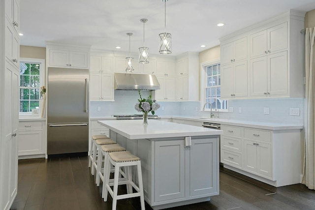 29 Brian Ct, Carmel, NY 10512 - kitchen featuring stainless steel built in fridge, under cabinet range hood, white cabinets, and recessed lighting