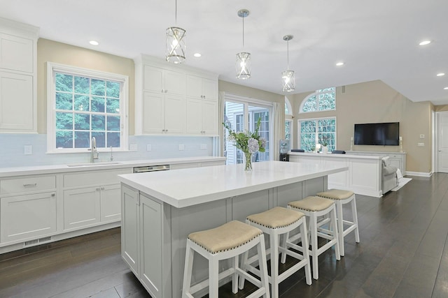29 Brian Ct, Carmel, NY 10512 - kitchen with a kitchen island, dark wood-style floors, tasteful backsplash, white cabinetry, and recessed lighting
