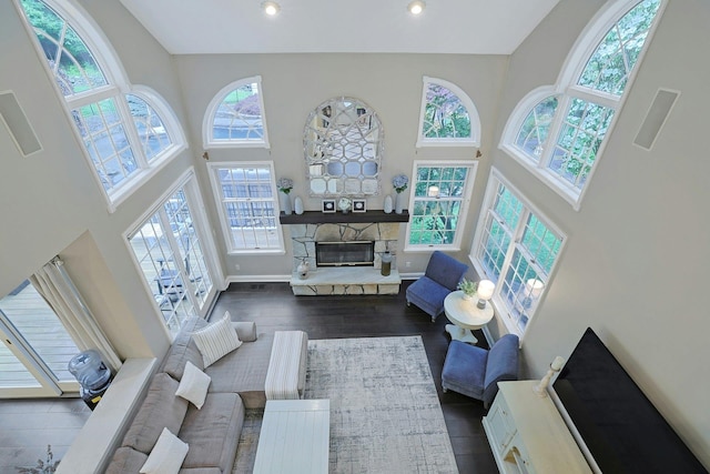 29 Brian Ct, Carmel, NY 10512 - living room with a high ceiling, a stone fireplace, dark wood-type flooring, and recessed lighting