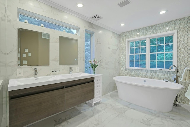 29 Brian Ct, Carmel, NY 10512 - bathroom with double vanity, marble tiled floors, a soaking tub, ornamental molding, and recessed lighting