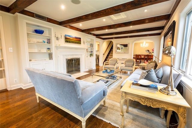 15 Glen Pk Rd, Purchase, NY 10577 - living area featuring arched walkways, dark wood-style floors, a premium fireplace, beam ceiling, and stairway