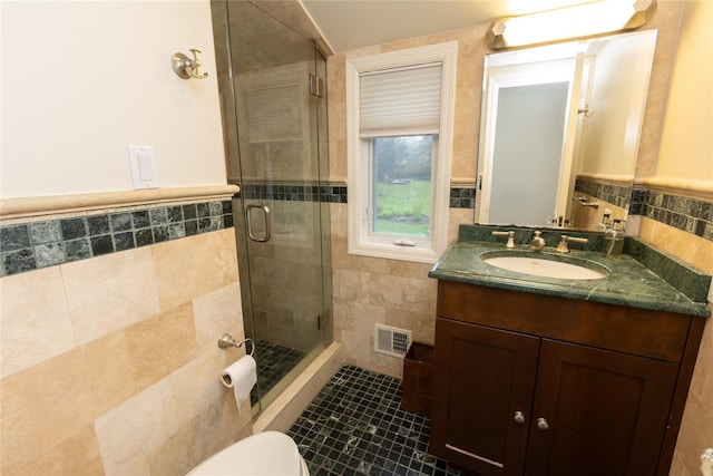 15 Glen Pk Rd, Purchase, NY 10577 - full bathroom featuring tile walls, a stall shower, vanity, tile patterned floors, and wainscoting
