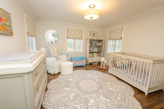 15 Glen Pk Rd, Purchase, NY 10577 - bedroom with multiple windows, a nursery area, and wood finished floors
