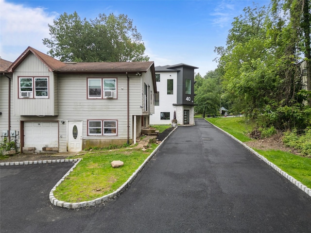 14 Singer Ave, Spring Valley, NY 10977 - view of front facade featuring asphalt driveway and a garage