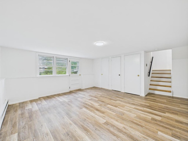 811 Bellmore Ave, East Meadow, NY 11554 - unfurnished bedroom featuring light wood-type flooring, two closets, and baseboard heating