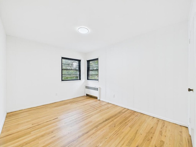 811 Bellmore Ave, East Meadow, NY 11554 - unfurnished room with radiator heating unit and wood finished floors