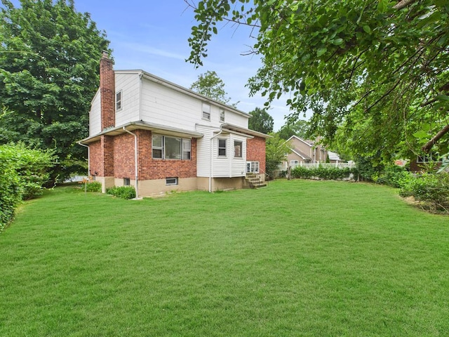 811 Bellmore Ave, East Meadow, NY 11554 - back of house featuring a chimney, brick siding, and entry steps