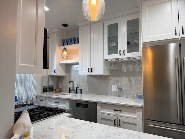 1273 N Ave Unit 4F-5, New Rochelle, NY 10804 - kitchen with stainless steel appliances, decorative backsplash, glass insert cabinets, white cabinets, and light stone counters