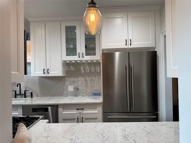 1273 N Ave Unit 4F-5, New Rochelle, NY 10804 - kitchen featuring appliances with stainless steel finishes, glass insert cabinets, white cabinetry, and decorative backsplash