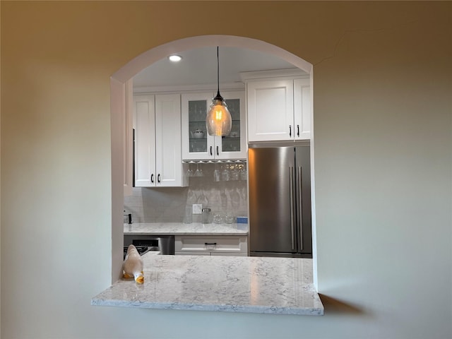 1273 N Ave Unit 4F-5, New Rochelle, NY 10804 - kitchen with freestanding refrigerator, glass insert cabinets, decorative backsplash, white cabinetry, and recessed lighting