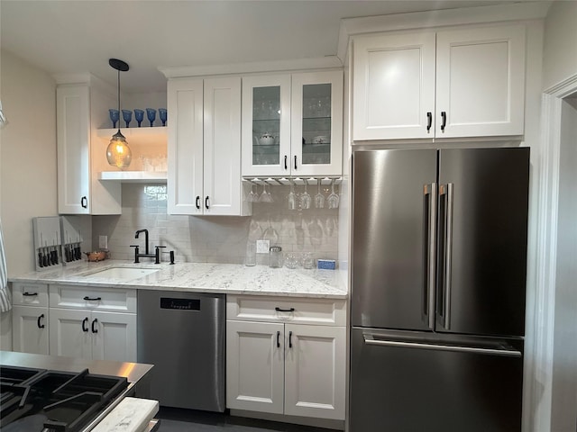 1273 N Ave Unit 4F-5, New Rochelle, NY 10804 - kitchen featuring appliances with stainless steel finishes, white cabinets, and tasteful backsplash