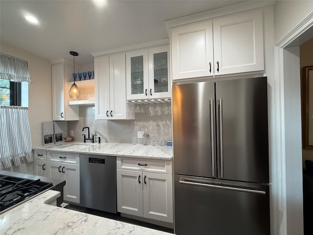 1273 N Ave Unit 4F-5, New Rochelle, NY 10804 - kitchen with appliances with stainless steel finishes, backsplash, white cabinets, glass insert cabinets, and recessed lighting