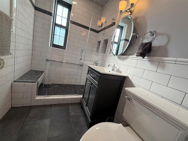 1273 N Ave Unit 4F-5, New Rochelle, NY 10804 - bathroom with tile walls, a stall shower, tile patterned flooring, and vanity