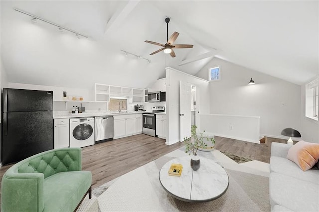 27 County Route 19, Hudson, NY 12534 - living area featuring washer / clothes dryer, track lighting, light wood-type flooring, vaulted ceiling, and a ceiling fan