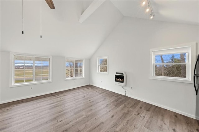 27 County Route 19, Hudson, NY 12534 - unfurnished living room with heating unit, lofted ceiling, wood finished floors, track lighting, and healthy amount of natural light